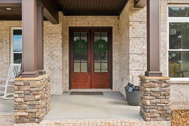 doorway to property with french doors and a porch