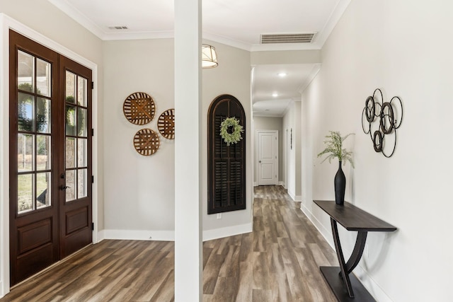 foyer with french doors, ornamental molding, and dark hardwood / wood-style floors