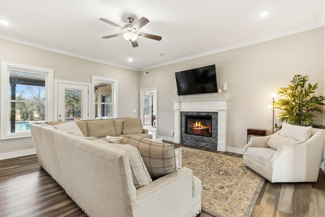 living room with ceiling fan, crown molding, and dark hardwood / wood-style flooring