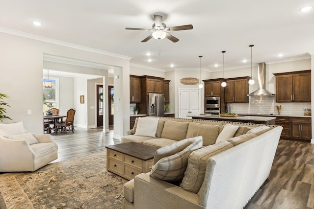 living room featuring ceiling fan, ornamental molding, and dark hardwood / wood-style floors