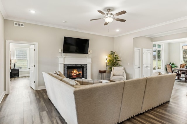 living room featuring ceiling fan, crown molding, and dark hardwood / wood-style floors