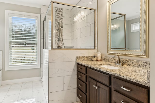 bathroom with vanity, an enclosed shower, and a wealth of natural light