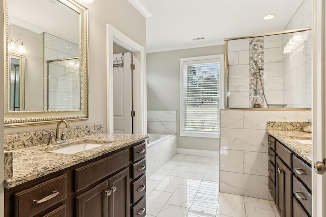 bathroom featuring vanity and a relaxing tiled tub