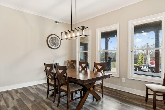 dining area featuring crown molding and dark hardwood / wood-style floors