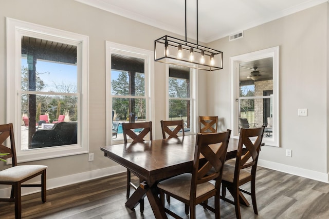 dining space featuring crown molding and dark hardwood / wood-style floors