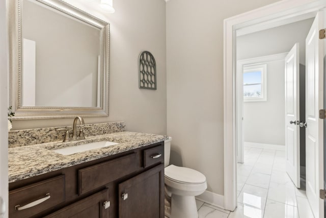 bathroom featuring toilet and vanity