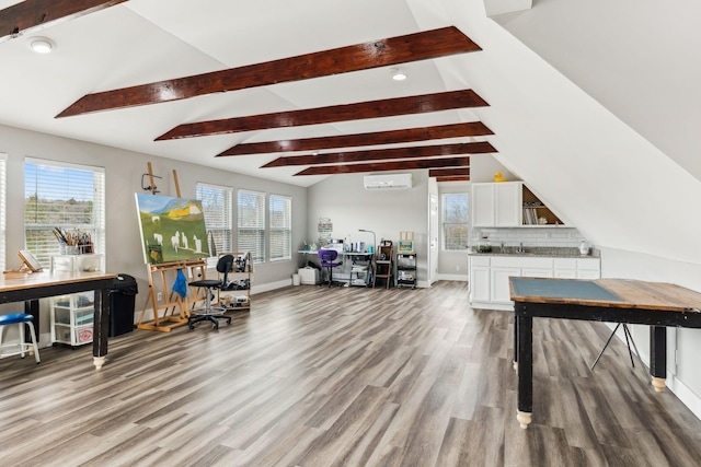 interior space with hardwood / wood-style floors and vaulted ceiling with beams