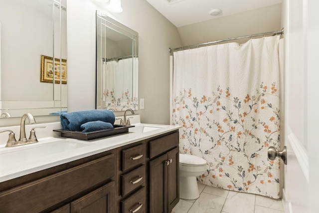 bathroom featuring toilet and vanity