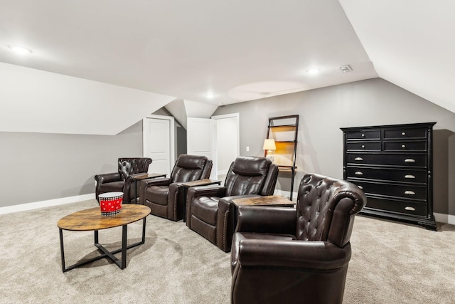 carpeted cinema room featuring lofted ceiling