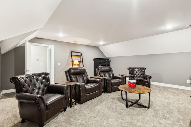 cinema room with vaulted ceiling and light colored carpet