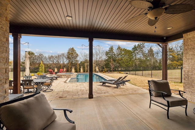 view of patio with ceiling fan and a fenced in pool