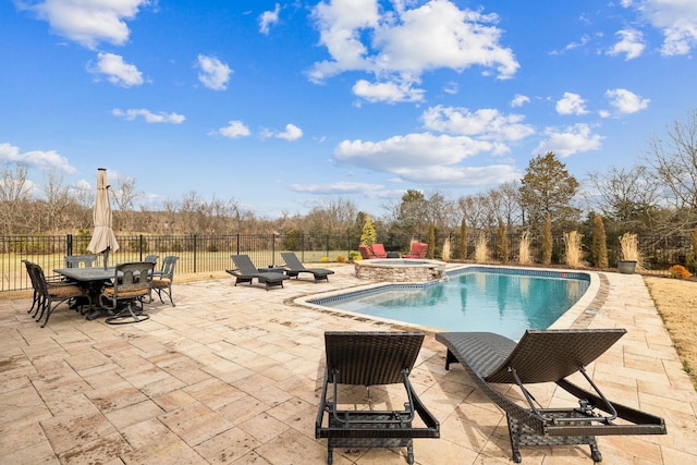 view of swimming pool featuring an in ground hot tub and a patio area