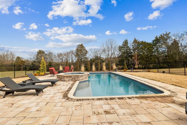 view of pool featuring a patio and an in ground hot tub