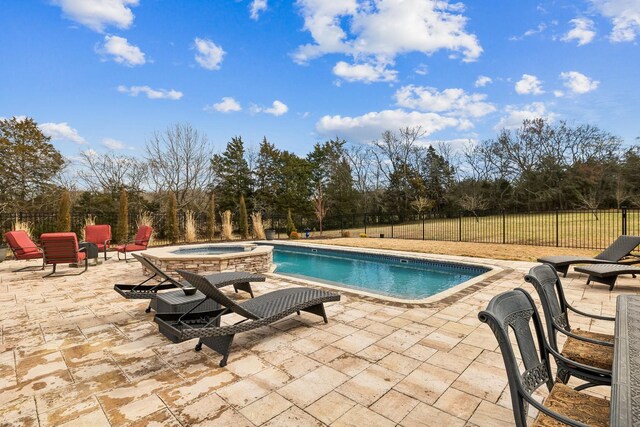 view of swimming pool with an in ground hot tub and a patio area