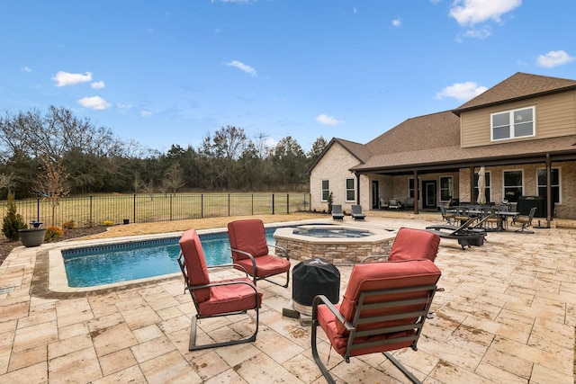 view of pool with an in ground hot tub and a patio area