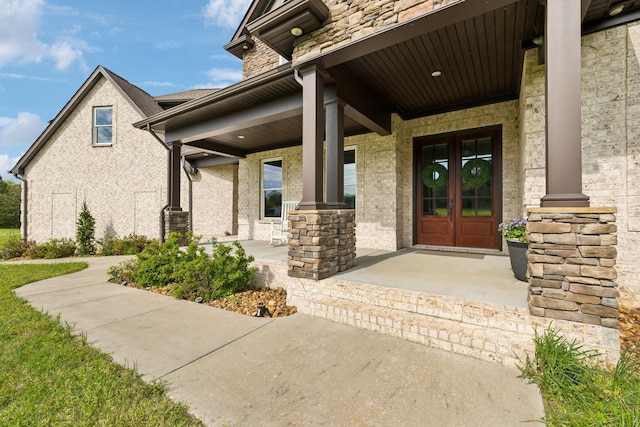 8760 Rocky Fork Rd, Smyrna, TN 37167 - entrance to property featuring french doors, covered porch, and stone siding