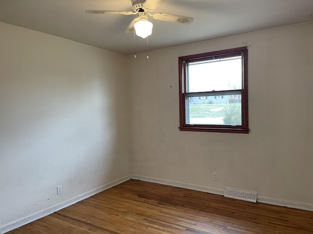 unfurnished room featuring dark hardwood / wood-style floors and ceiling fan