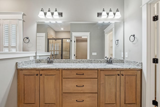 bathroom featuring an enclosed shower and vanity