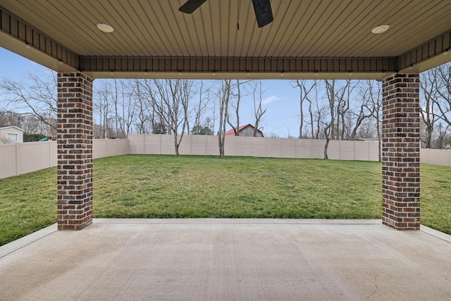 view of yard with ceiling fan and a patio area