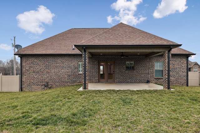 rear view of house with a patio area and a lawn