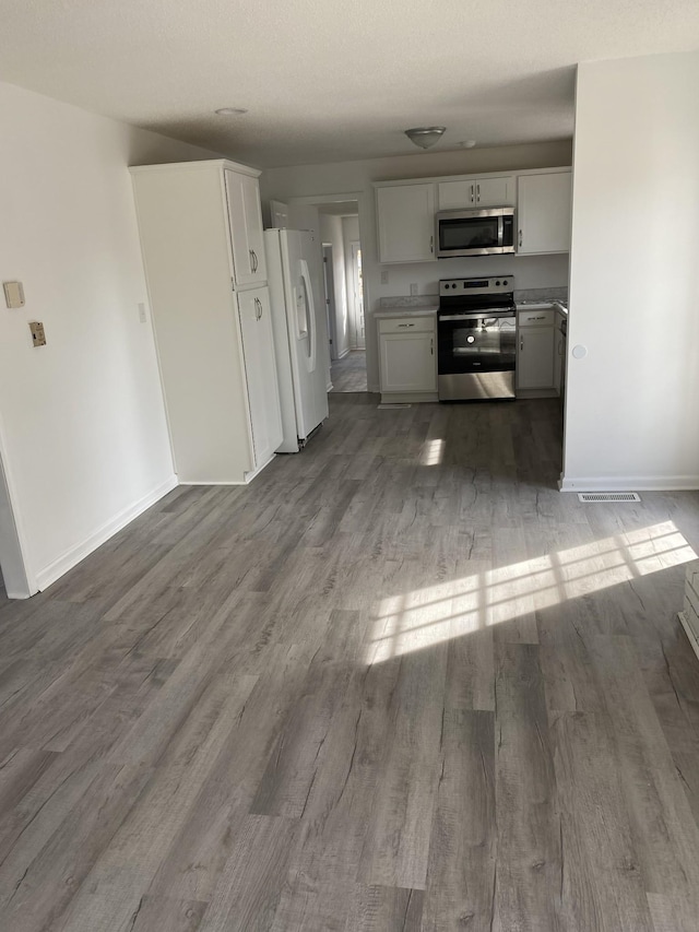 kitchen featuring white cabinetry, dark hardwood / wood-style floors, and appliances with stainless steel finishes