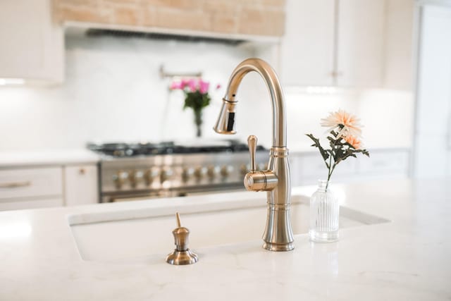 details with white cabinetry, sink, and light stone counters