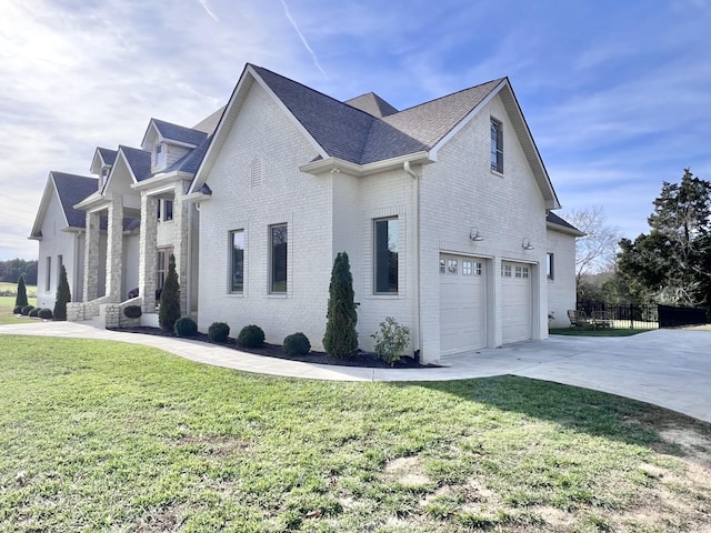 view of side of property with a garage and a lawn