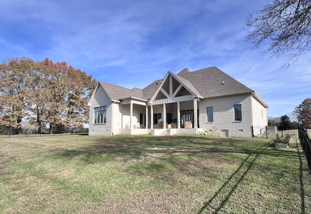 rear view of property featuring a patio area and a lawn