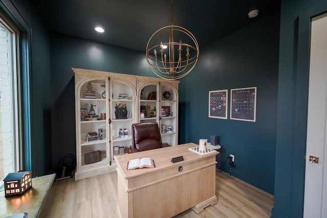 home office featuring light hardwood / wood-style flooring and a chandelier