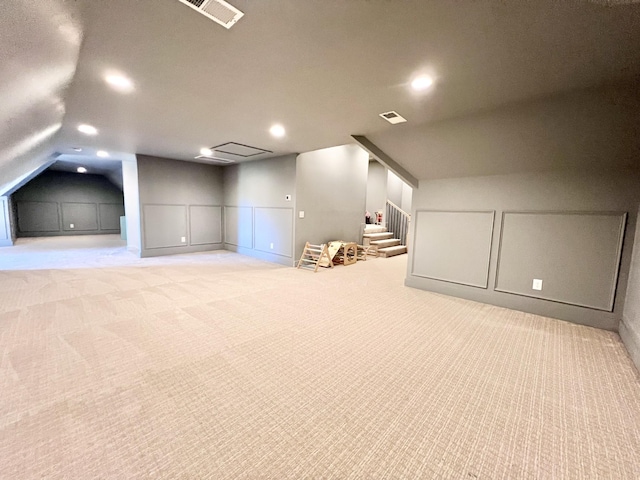 additional living space with light carpet and lofted ceiling