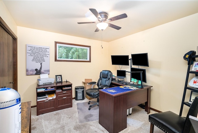 carpeted office space featuring ceiling fan