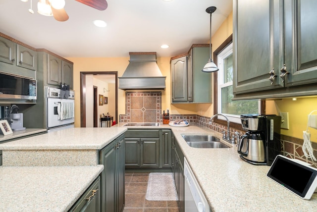 kitchen featuring white appliances, custom range hood, decorative backsplash, pendant lighting, and sink