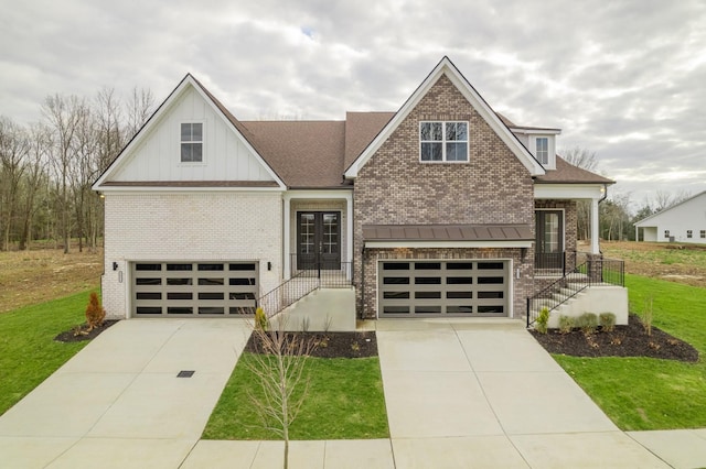 craftsman-style home featuring driveway, board and batten siding, a front yard, a garage, and brick siding