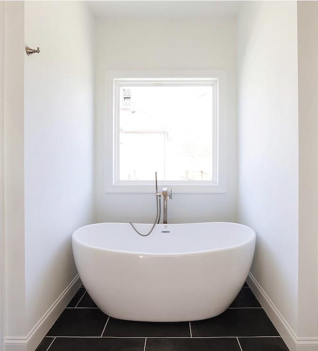 bathroom featuring tile patterned floors and a bath