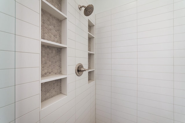 interior details with a tile shower