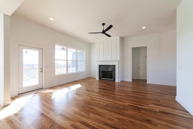 unfurnished living room featuring hardwood / wood-style floors and ceiling fan