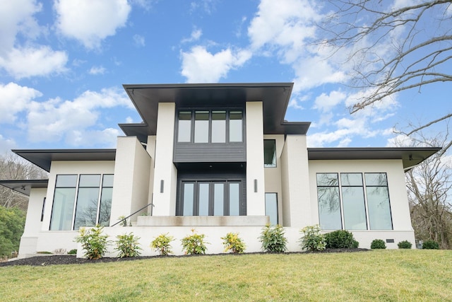 rear view of property featuring a yard