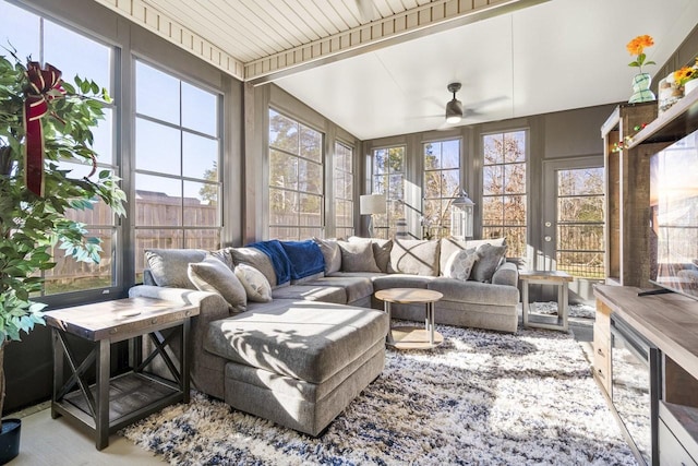 sunroom / solarium with ceiling fan and beam ceiling