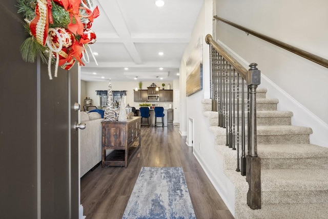 foyer entrance featuring coffered ceiling, beam ceiling, and dark hardwood / wood-style flooring