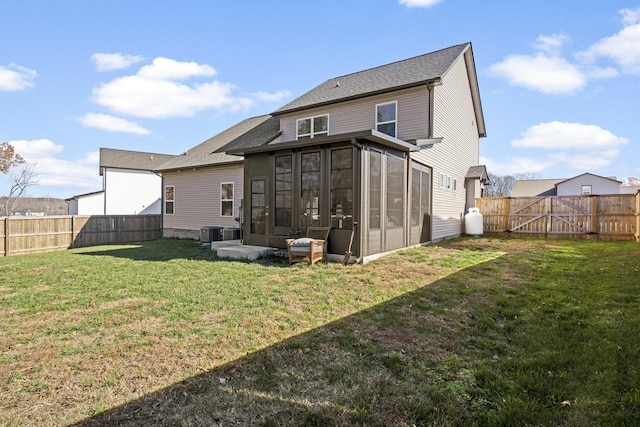 back of house featuring cooling unit, a lawn, and a sunroom