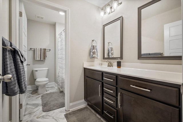 bathroom featuring vanity and toilet