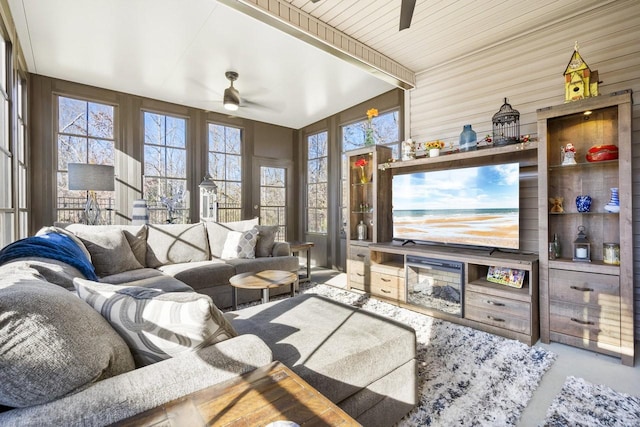 living room with beamed ceiling and ceiling fan