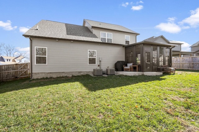 back of property with a patio, a sunroom, a yard, and central air condition unit