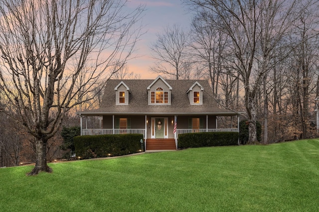 view of front of property with a lawn and a porch