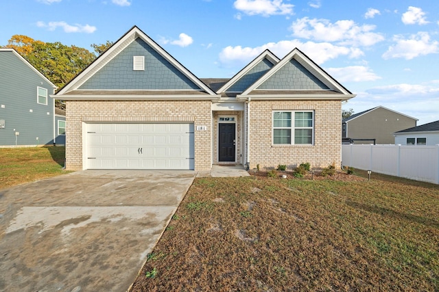 craftsman-style home featuring a garage and a front yard