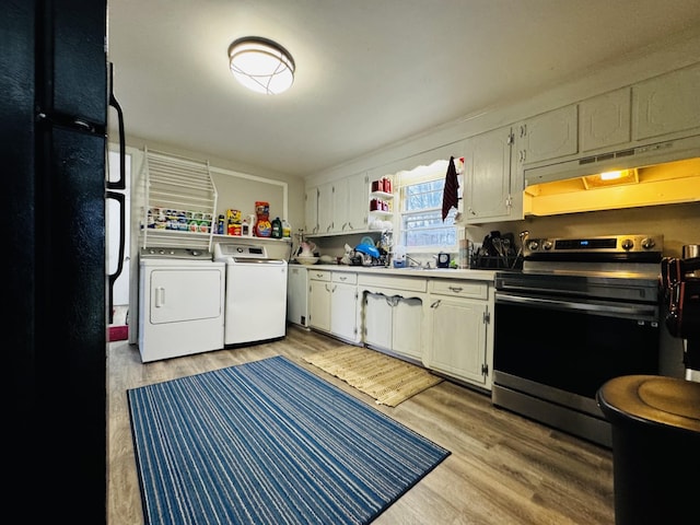 kitchen featuring white cabinetry, washer and clothes dryer, stainless steel range with electric cooktop, and light hardwood / wood-style flooring