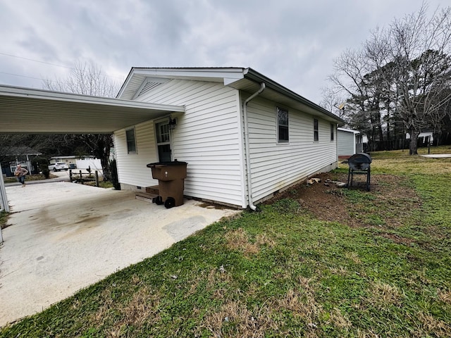 view of home's exterior with a yard and a carport