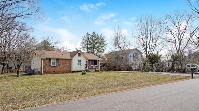 view of front of property featuring cooling unit and a front lawn