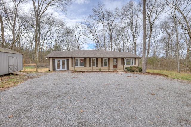 single story home with a storage unit and french doors