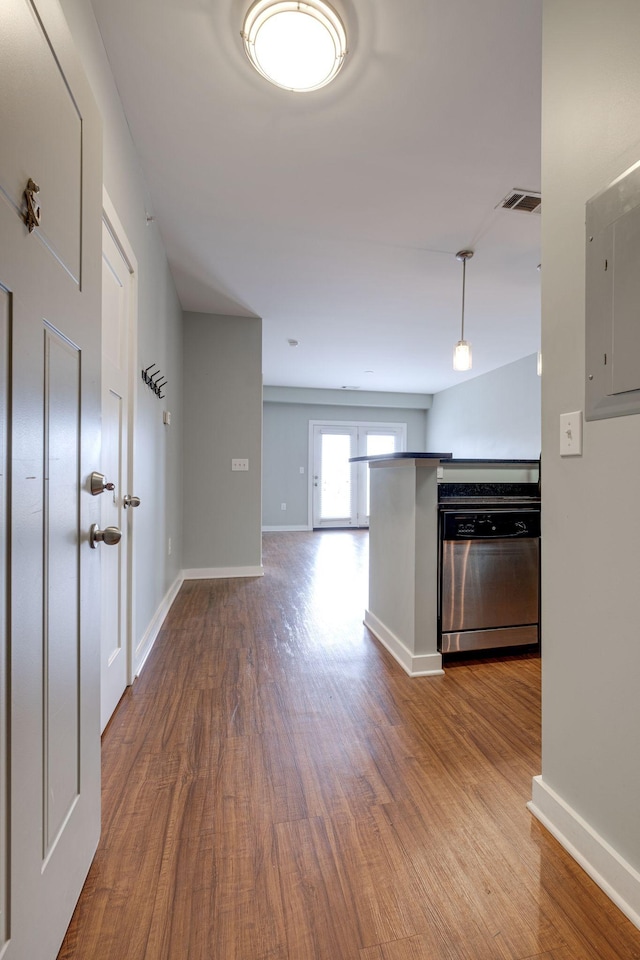 hallway featuring hardwood / wood-style flooring and electric panel